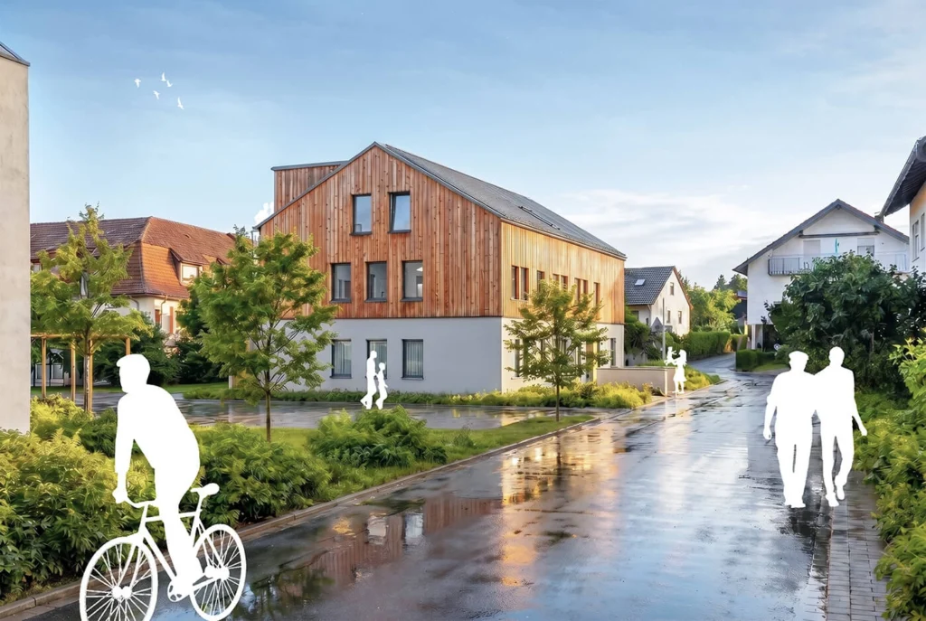 Visualisierung eines modernen Mehrfamilienhauses in Offenburg-Rammersweier mit hochwertiger Holzfassade, gepflegten Außenanlagen und attraktiver Wohnlage für Familien und Paare.