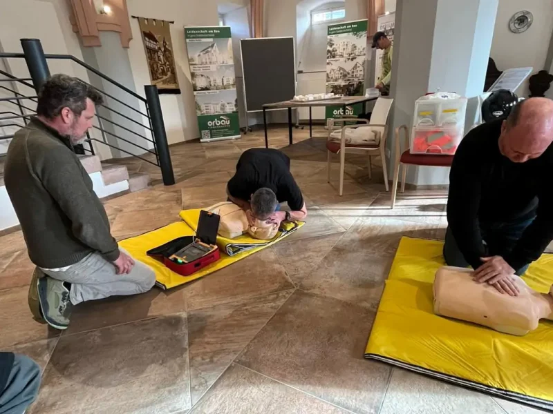 Gewerbliche Mitarbeiter von orbau nehmen an einer Ersthelfer-Auffrischung teil.
