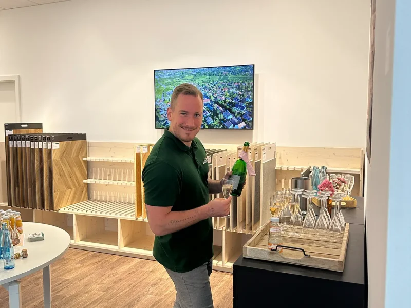 Mitarbeiter schenkt Sekt für Gäste des Pre-Sale Events der orbau Firmengruppe ein